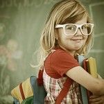 Cheerful colorized retro fashion little girl at school room havi
